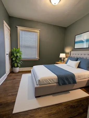 a bedroom with a large bed and a potted plant
