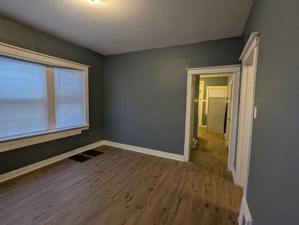 a view of an empty room and wooden floor