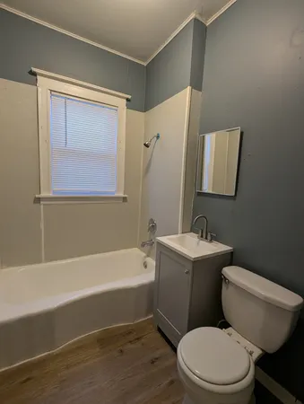 a bathroom with a toilet a sink and bathtub