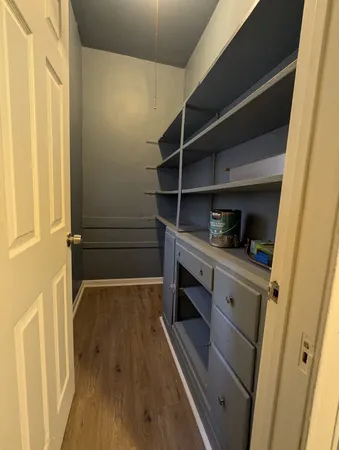 a view of walk in closet with empty racks