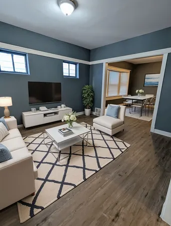 a living room with furniture a rug and a flat screen tv