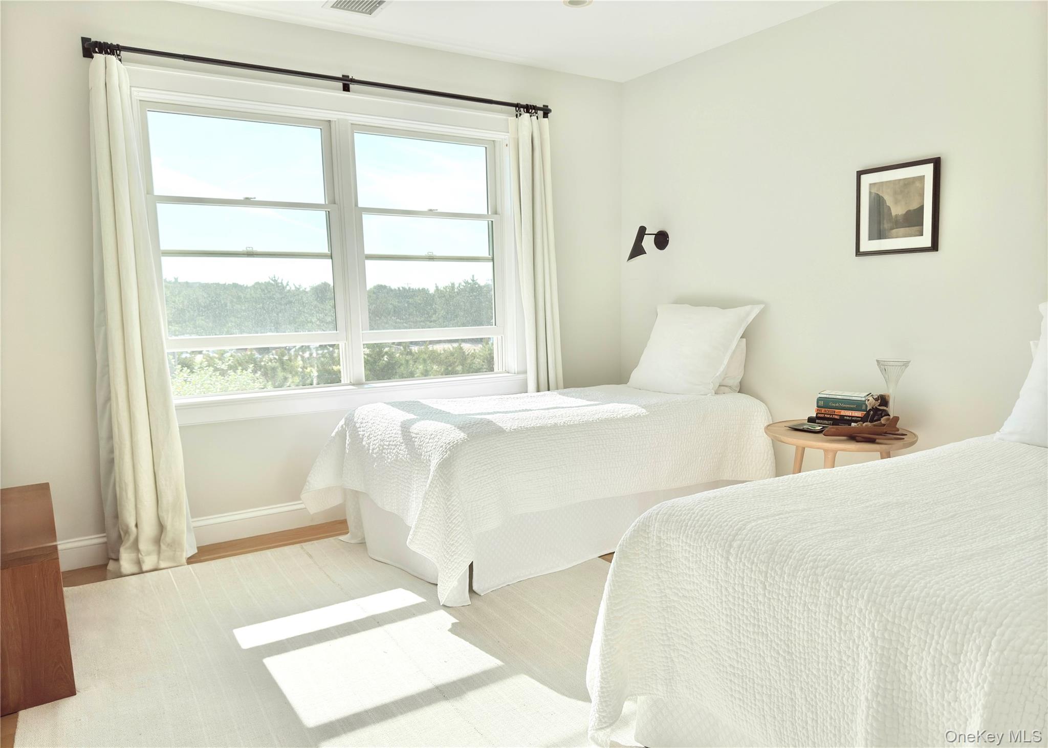 162 Dune Road Quogue, NY 11959 - Photo 15 of 28 a bed room with two beds and a large window