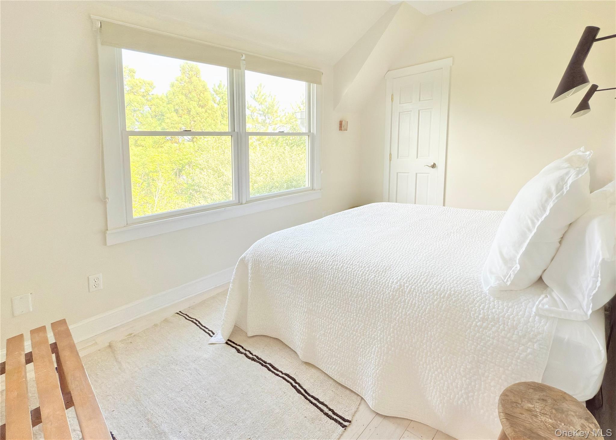 162 Dune Road Quogue, NY 11959 - Photo 17 of 28 a bedroom with a bed and a window