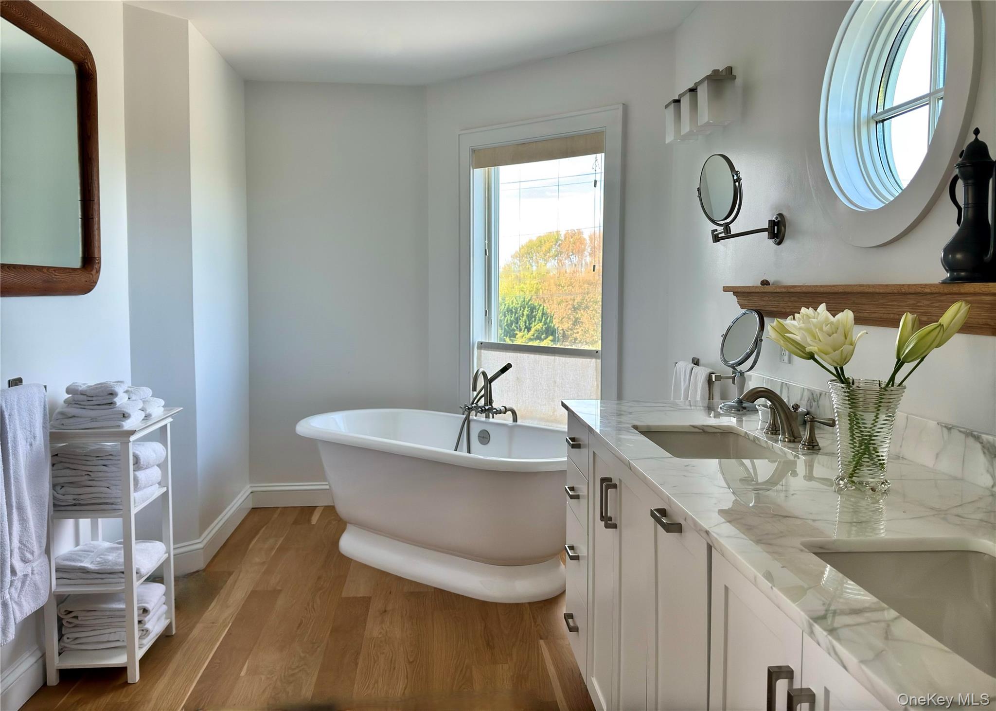 162 Dune Road Quogue, NY 11959 - Photo 18 of 28 a bathroom with a granite countertop sink and a mirror