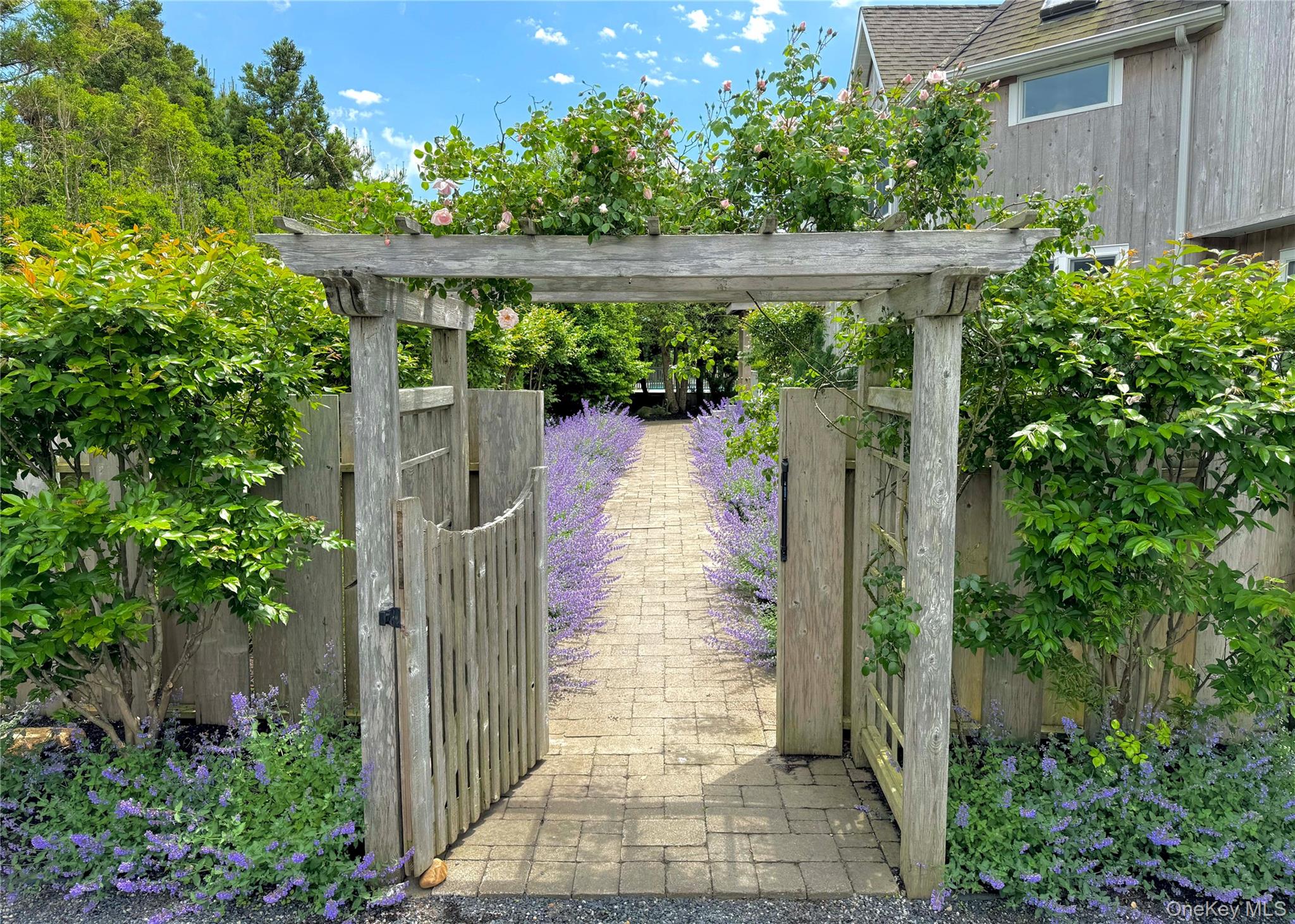 162 Dune Road Quogue, NY 11959 - Photo 2 of 28 a view of a pathway of a building