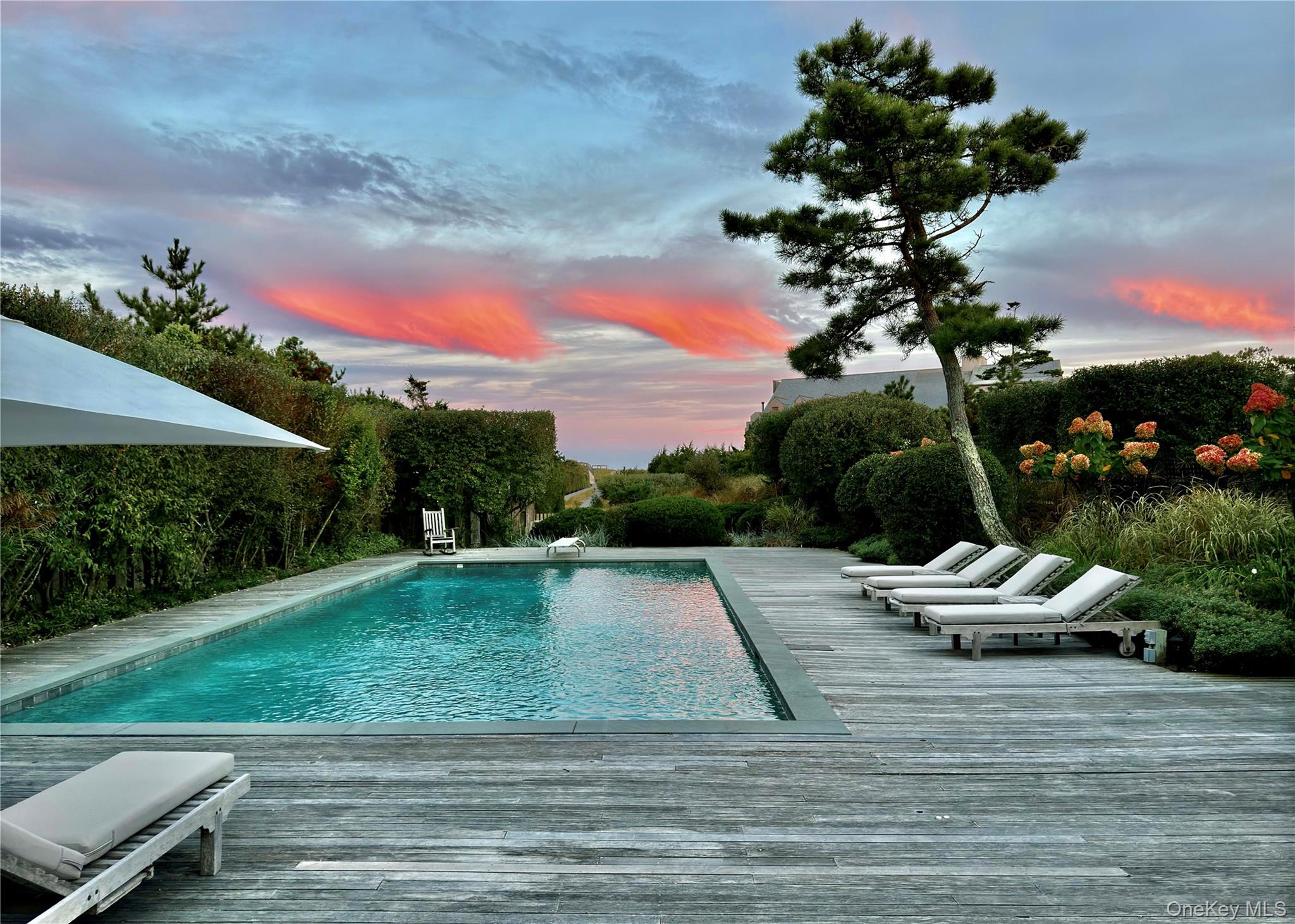 162 Dune Road Quogue, NY 11959 - Photo 26 of 28 a view of a backyard with a garden