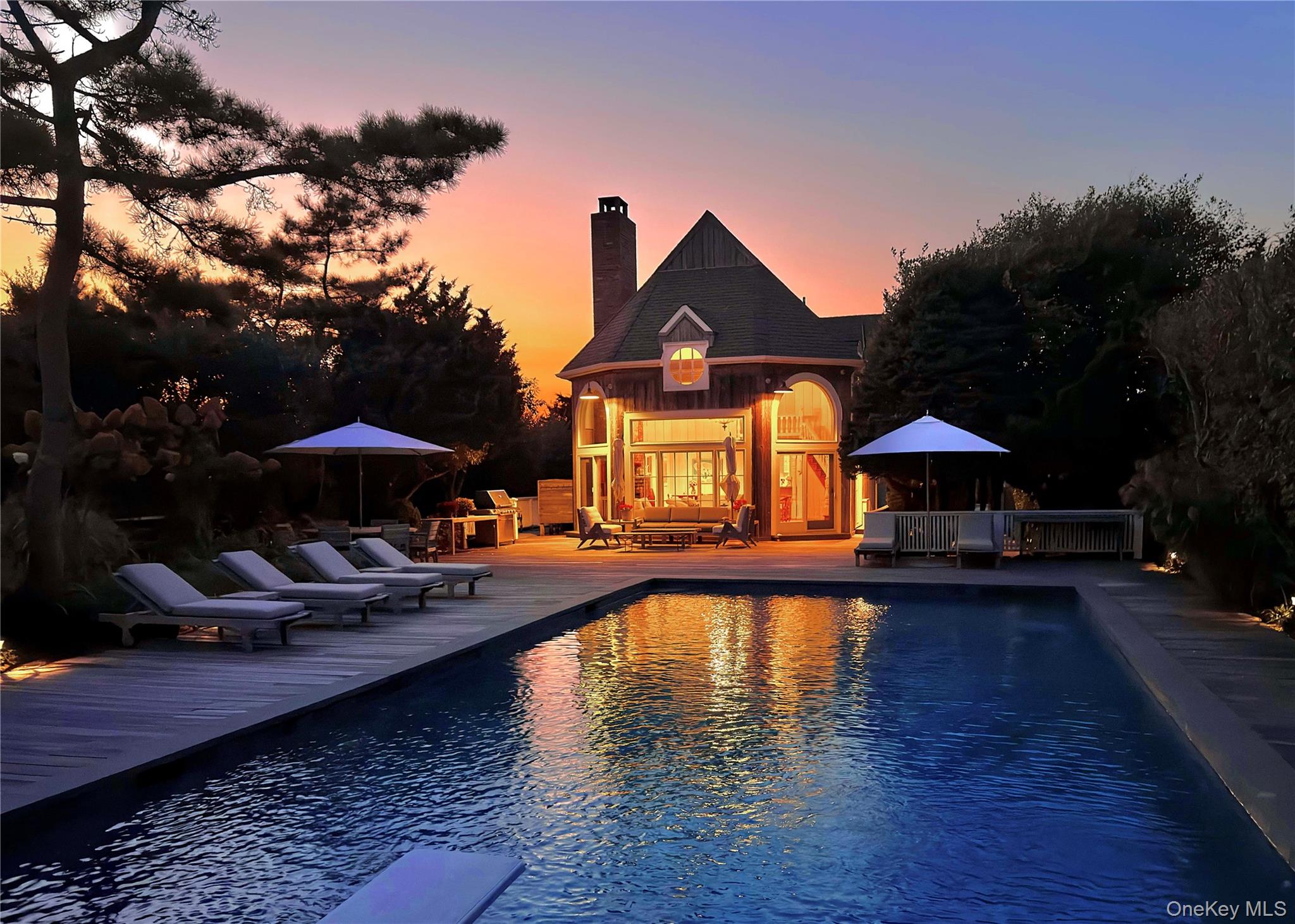 162 Dune Road Quogue, NY 11959 - Photo 27 of 28 a view of a house with pool yard fire pit and outdoor seating