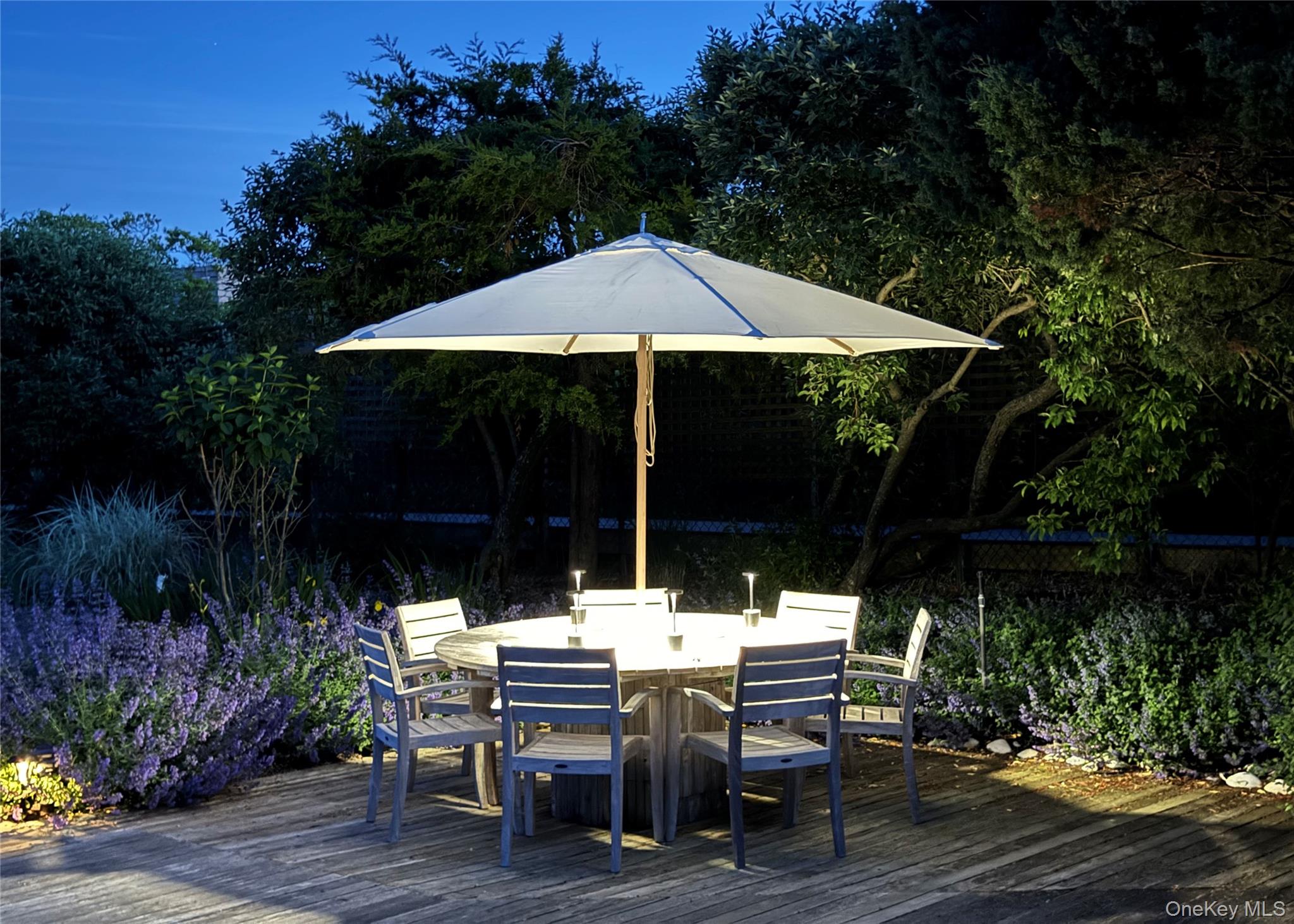 162 Dune Road Quogue, NY 11959 - Photo 28 of 28 a view of backyard with plants and outdoor seating
