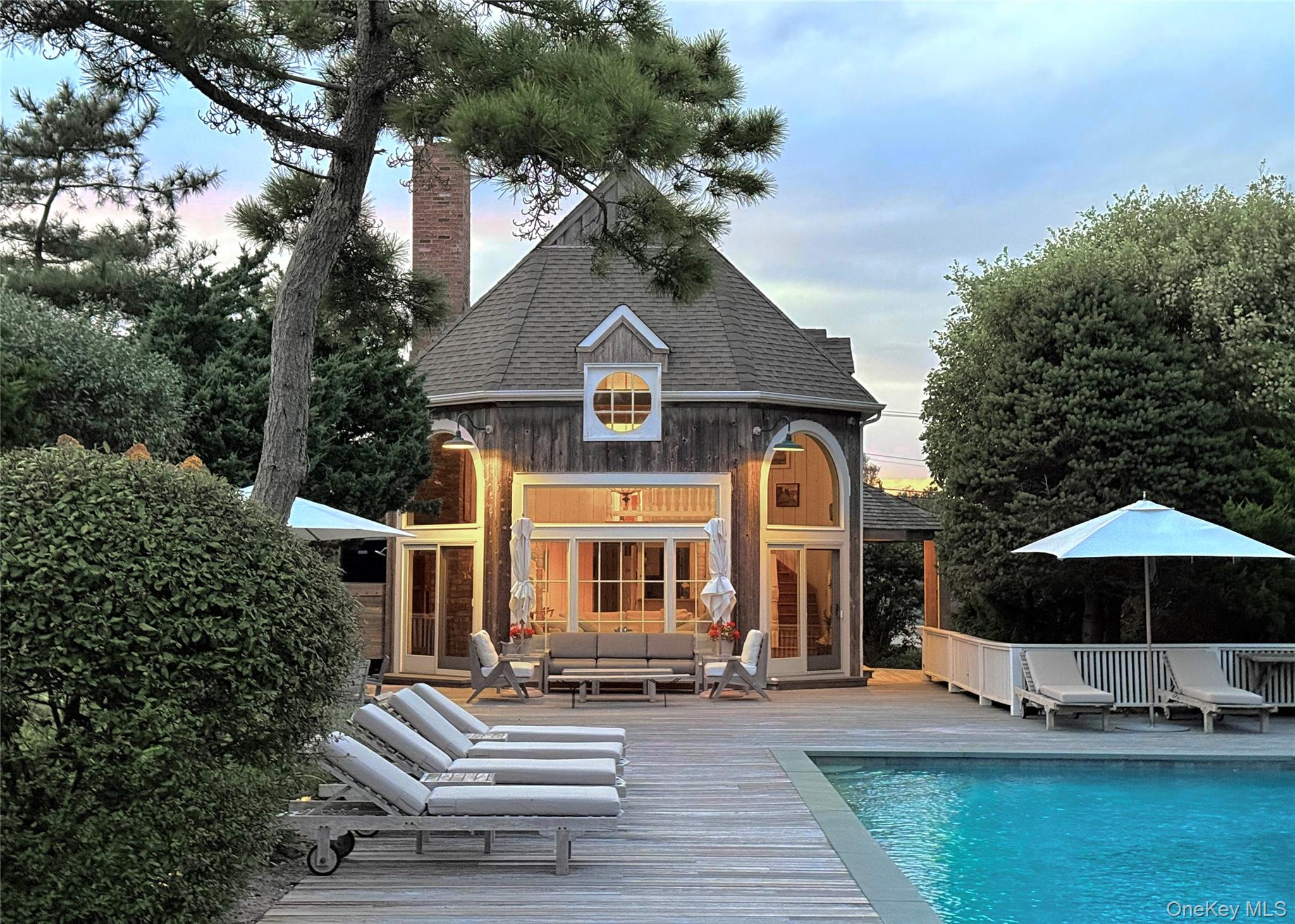 162 Dune Road Quogue, NY 11959 - Photo 4 of 28 a front view of a house with garden