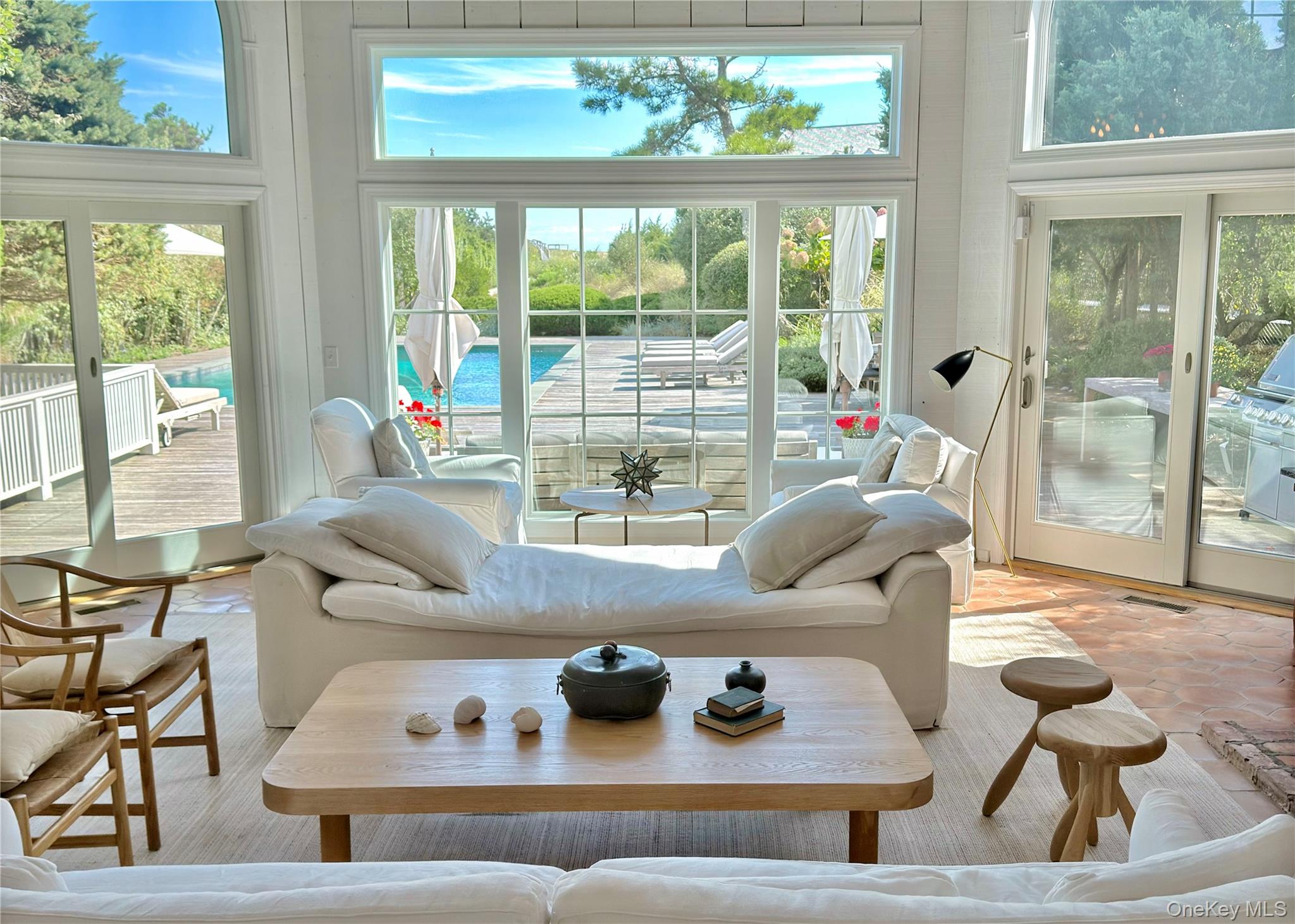 162 Dune Road Quogue, NY 11959 - Photo 6 of 28 a living room with furniture and a floor to ceiling window