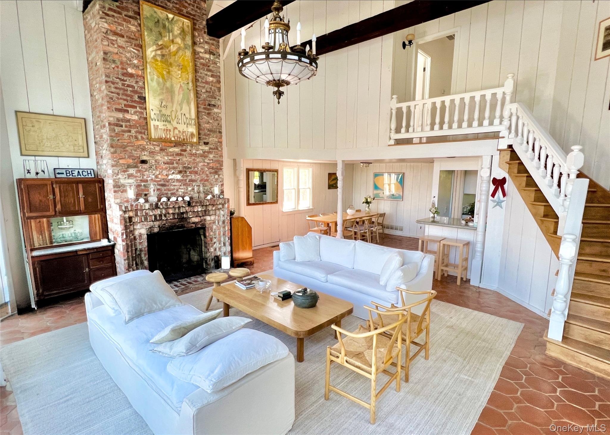 162 Dune Road Quogue, NY 11959 - Photo 7 of 28 a living room with furniture a fireplace and a table