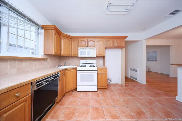 a kitchen with stainless steel appliances granite countertop a stove and a refrigerator