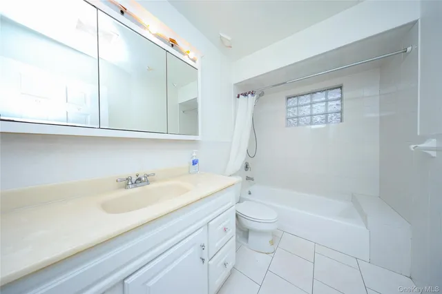 a bathroom with a sink a toilet and bathtub