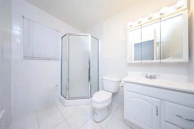 a bathroom with a toilet a sink and a mirror