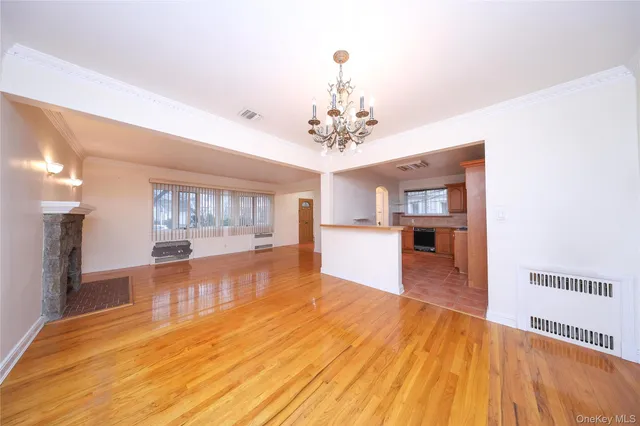 a view of a living room kitchen with a stove and wooden floor
