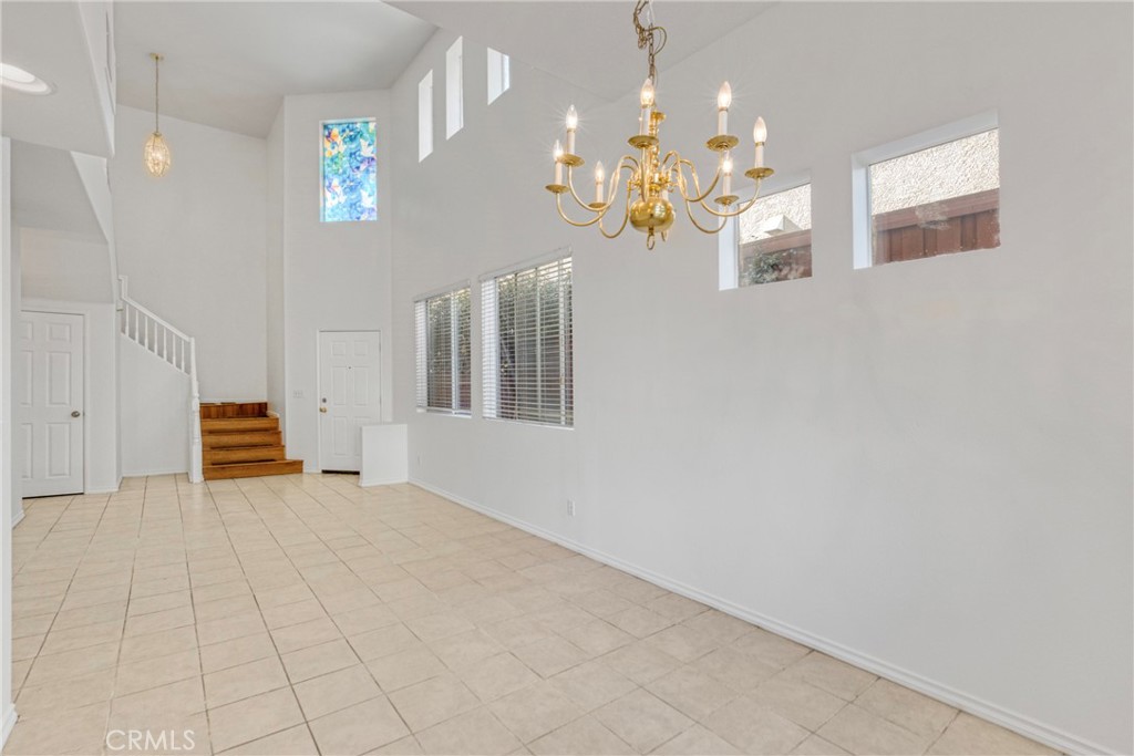 a view of a hallway with chandelier