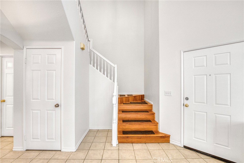 19321 Ackerman Avenue Newhall, CA 91321 - Photo 12 of 20 a view of a hallway with stairs and a rug