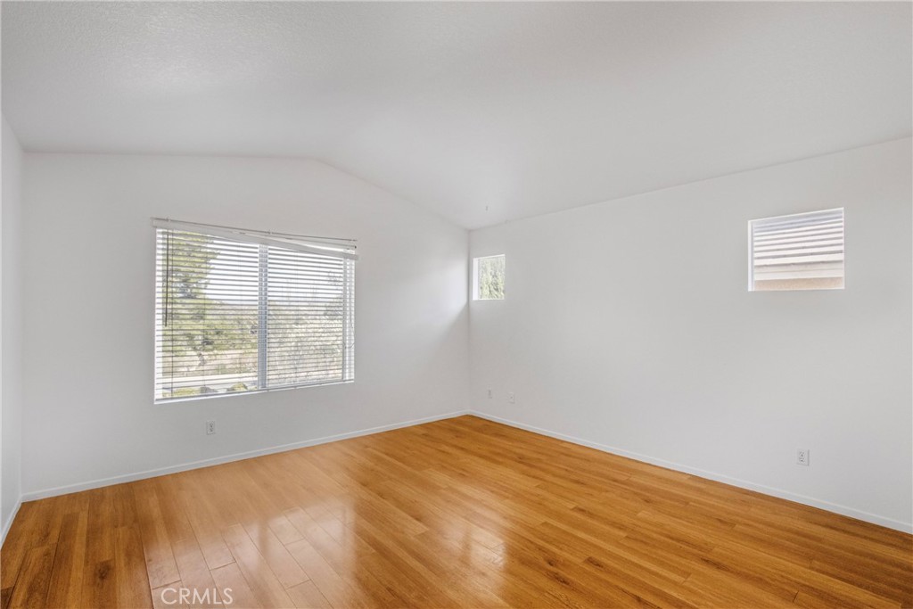 19321 Ackerman Avenue Newhall, CA 91321 - Photo 14 of 20 a view of an empty room with wooden floor and a window