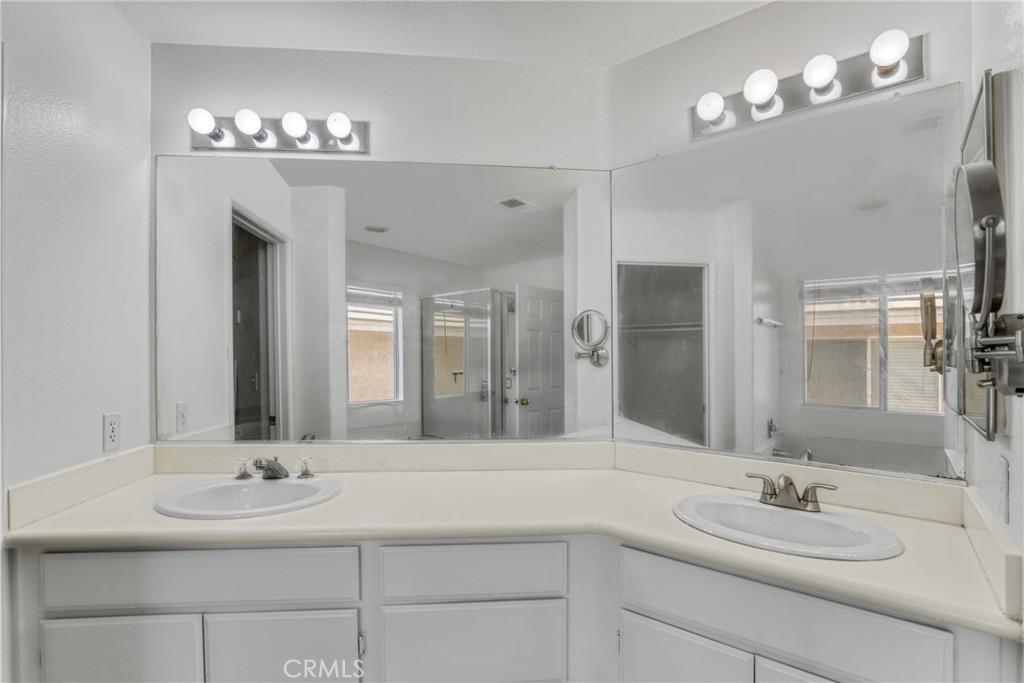19321 Ackerman Avenue Newhall, CA 91321 - Photo 15 of 20 a bathroom with a sink double vanity and a mirror