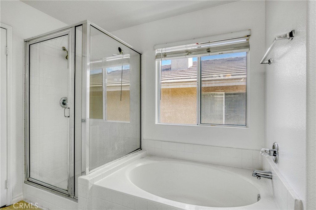 19321 Ackerman Avenue Newhall, CA 91321 - Photo 16 of 20 a bathroom with a tub and shower