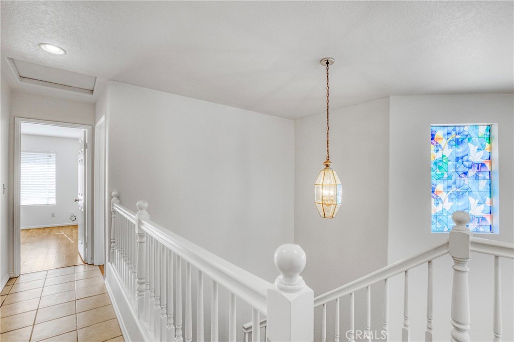 19321 Ackerman Avenue Newhall, CA 91321 - Photo 17 of 20 a view of a hallway to room with stair