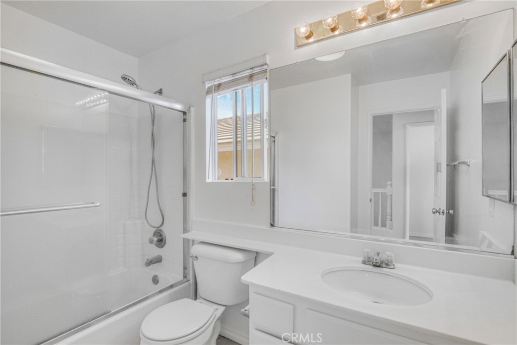 19321 Ackerman Avenue Newhall, CA 91321 - Photo 18 of 20 a bathroom with a sink toilet and shower