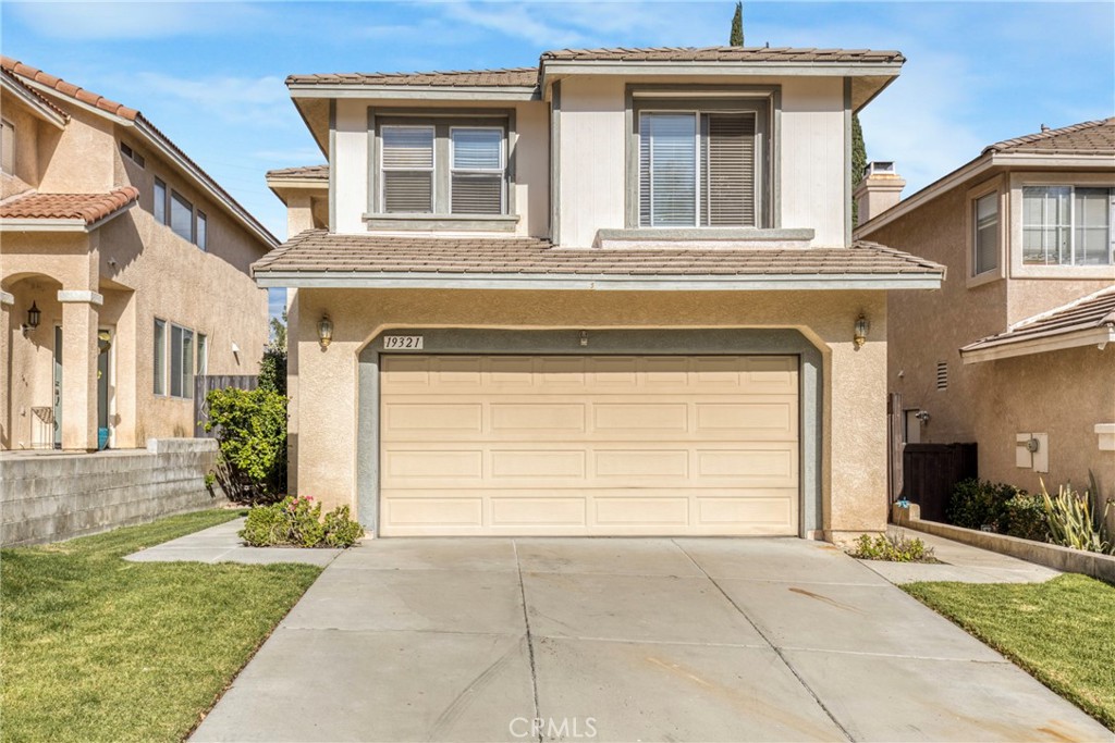 19321 Ackerman Avenue Newhall, CA 91321 - Photo 2 of 20 a view of a house with a yard and garage