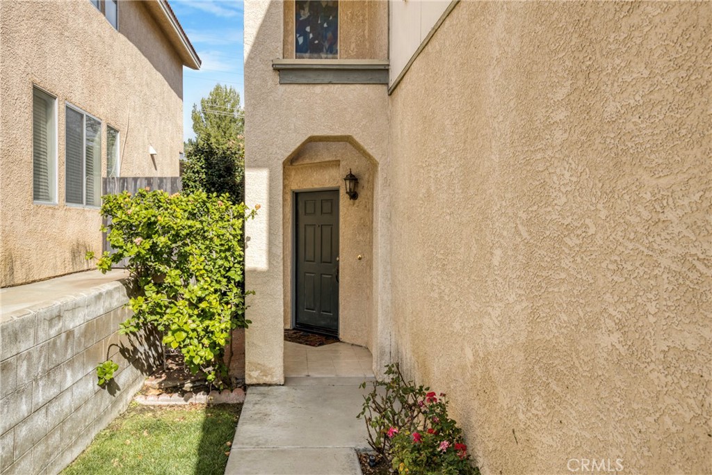 19321 Ackerman Avenue Newhall, CA 91321 - Photo 3 of 20 a front view of a house with a garden