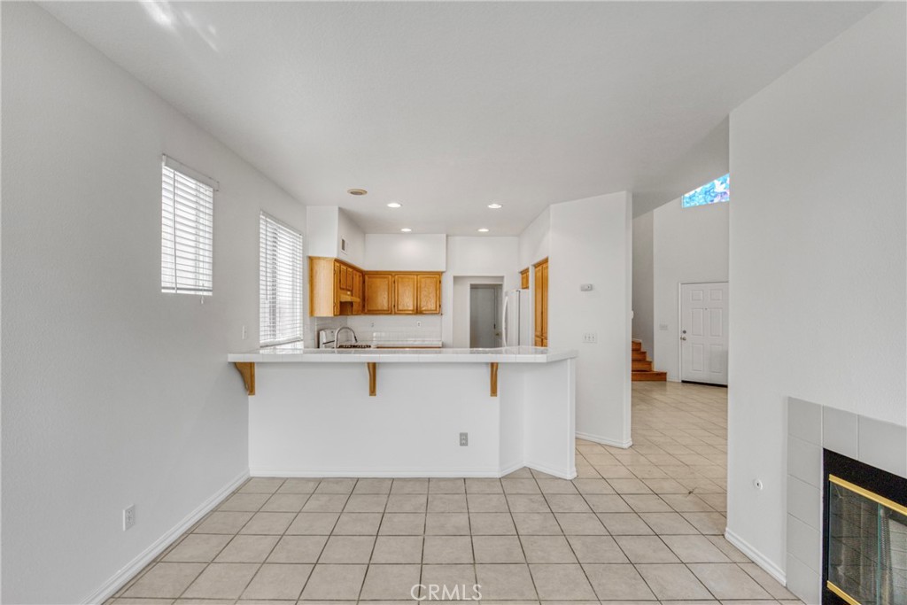 19321 Ackerman Avenue Newhall, CA 91321 - Photo 7 of 20 a view of kitchen with center island stainless steel appliances wooden floor and window
