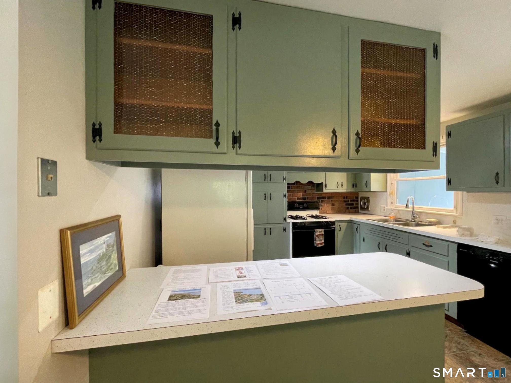 18 Old South Cove Road Old Saybrook, CT 06475 - Photo 19 of 40 a kitchen with cabinets and window