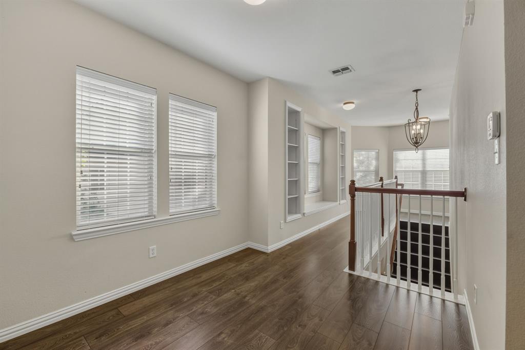 4027 Rome Court Irving, TX 75038 - Photo 14 of 33 a view of a hallway with wooden floor and windows