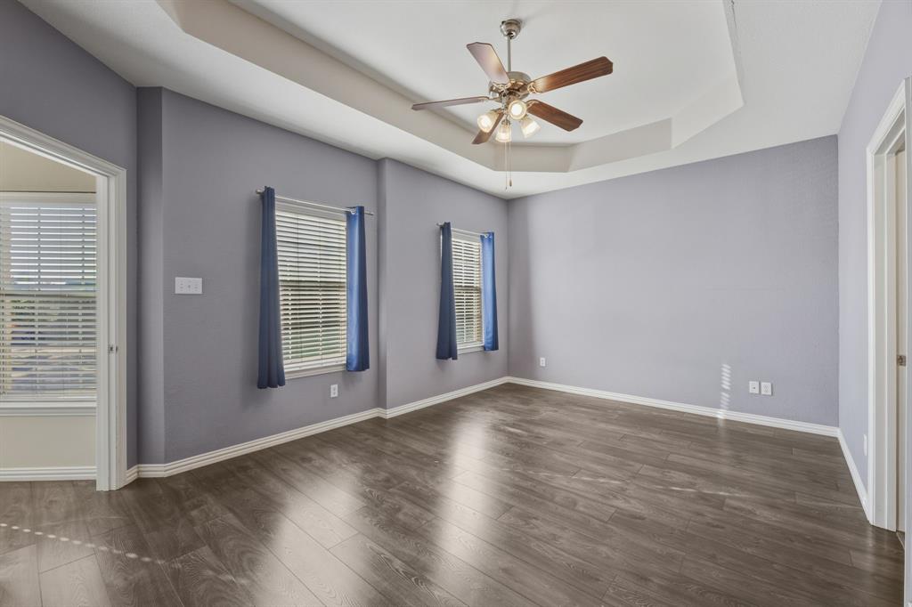 4027 Rome Court Irving, TX 75038 - Photo 16 of 33 an empty room with wooden floor chandelier and windows