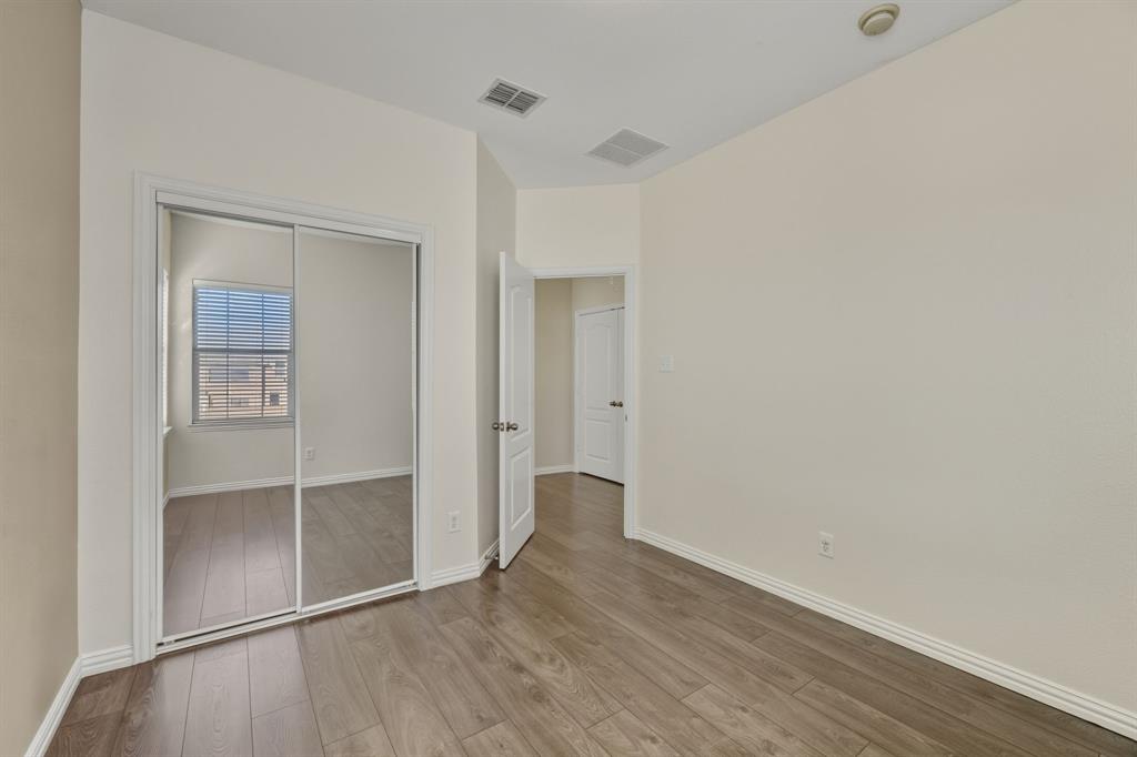 4027 Rome Court Irving, TX 75038 - Photo 24 of 33 an empty room with wooden floor