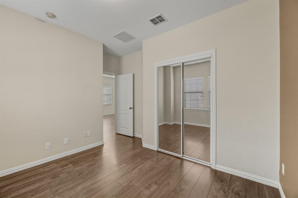 4027 Rome Court Irving, TX 75038 - Photo 28 of 33 an empty room with wooden floor and closet