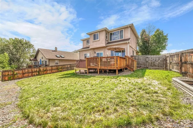 a view of a house with a yard and sitting area