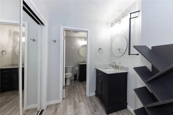 a en suite bathroom with a sink mirror and vanity