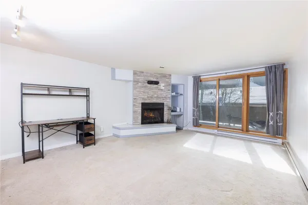 a view of an empty room with a fireplace