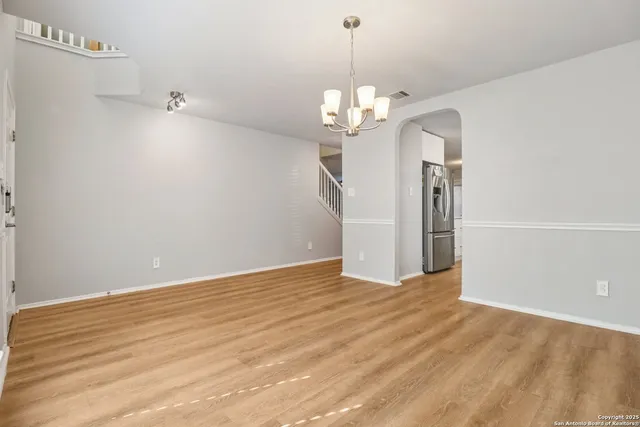 a view of a chandelier fan and entryway