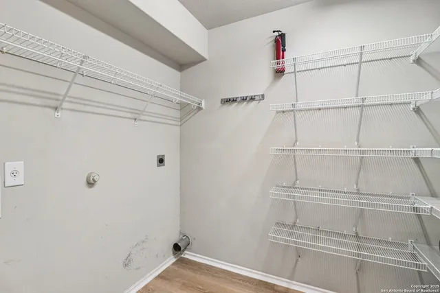 a view of walk in closet with empty racks