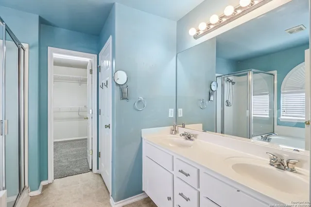 a bathroom with a sink double vanity and shower