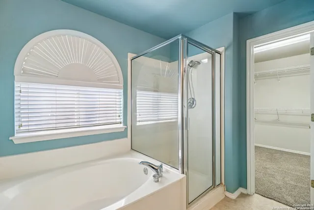 a bathroom with a bathtub and a shower
