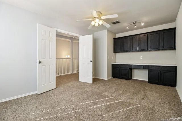 an empty room with a kitchen and a sink