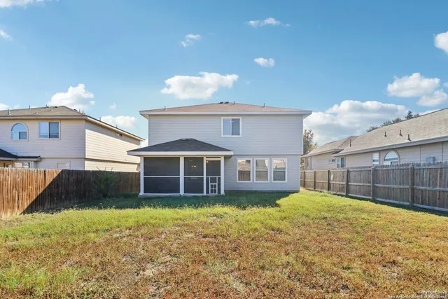 a view of a house with a yard and sitting area