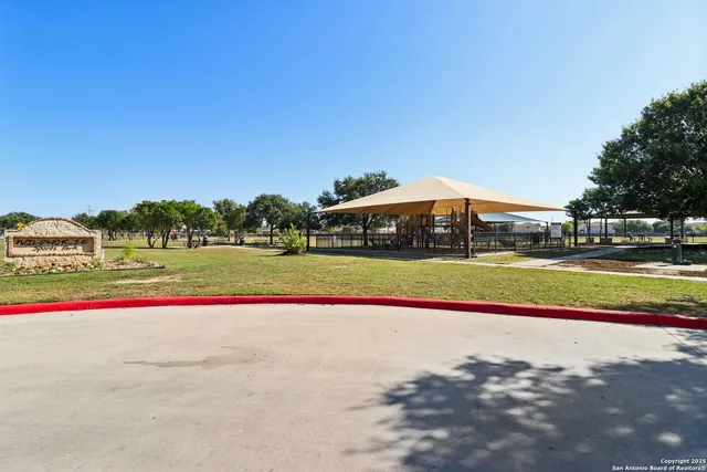 a view of outdoor space with playground and green space