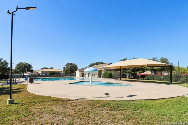 a swimming pool with outdoor seating and yard