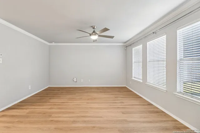 wooden floor in an empty room with a window