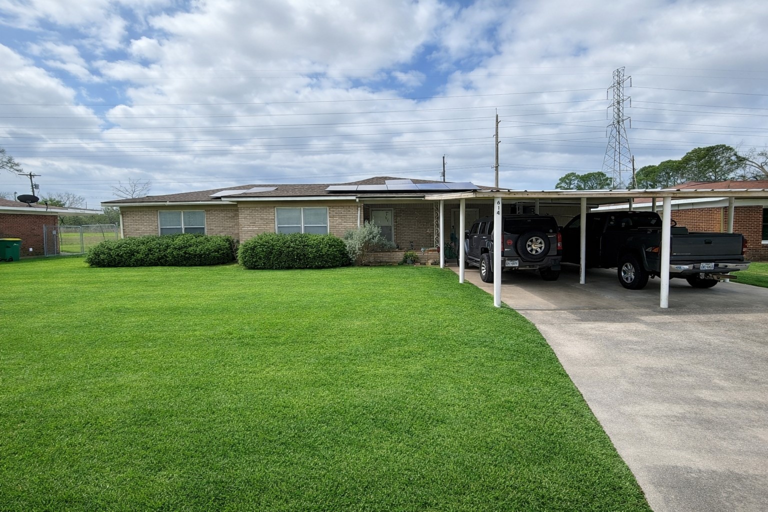 a view of a house with a yard and sitting area