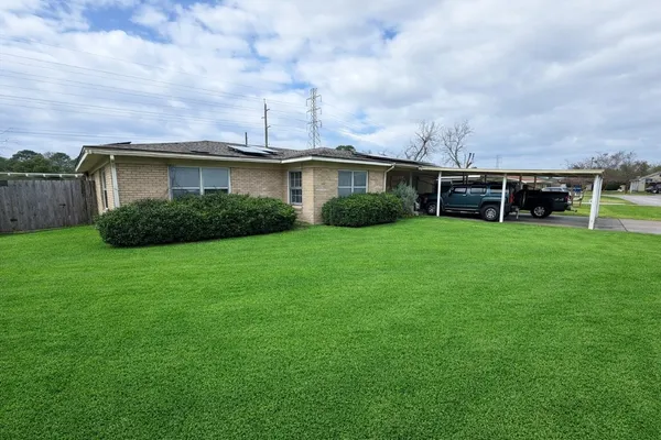 a view of a yard with a house in the background