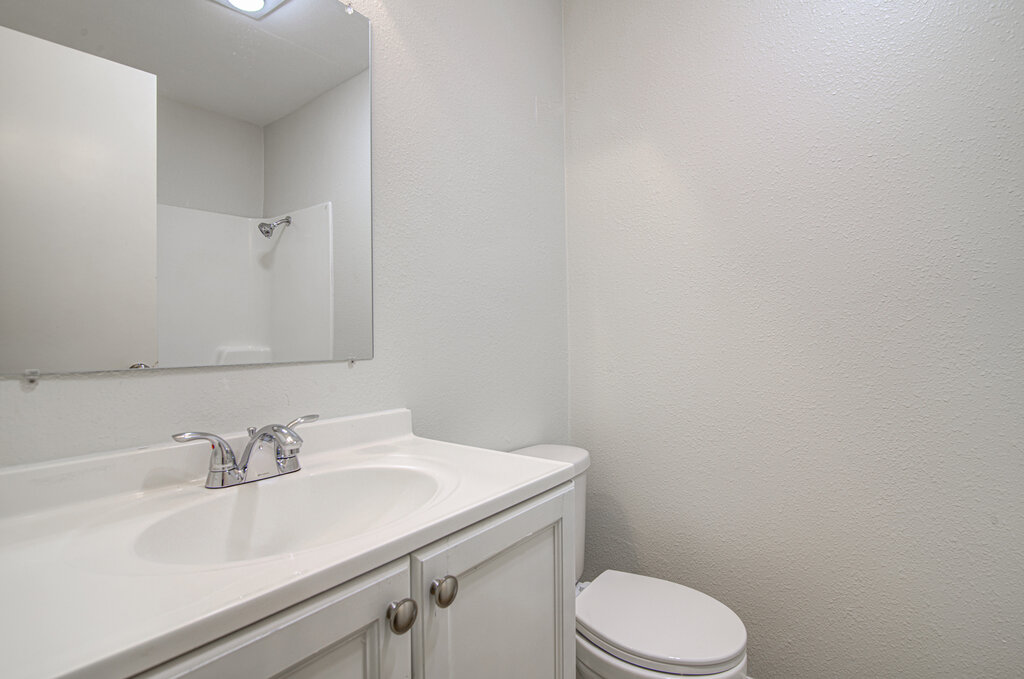 5301 Indio Circle, Unit A Austin, TX 78745 - Photo 13 of 25 A well-maintained bathroom with a sleek vanity and a shower reflected in the mirror.