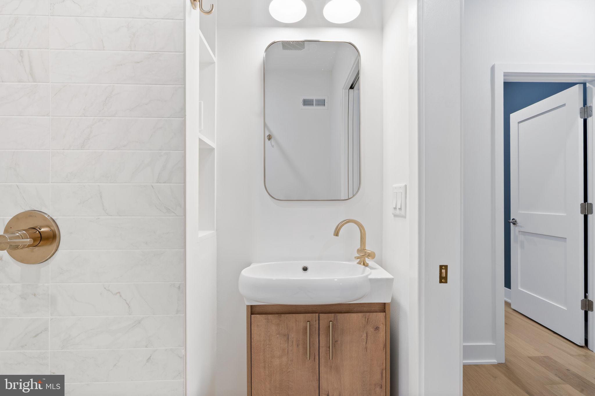 1318 South 8th Street Philadelphia, PA 19147 - Photo 21 of 47 a bathroom with a sink and mirror